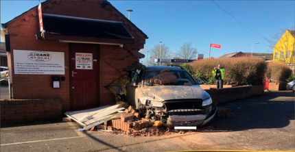 DRAMATIC PICTURES SHOW CAR CRASH INTO HINCKLEY TAXI OFFICE